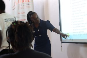 Caro Ayieko; head of Reproductive Health at Siaya county explaining youth friendly services guidelines.